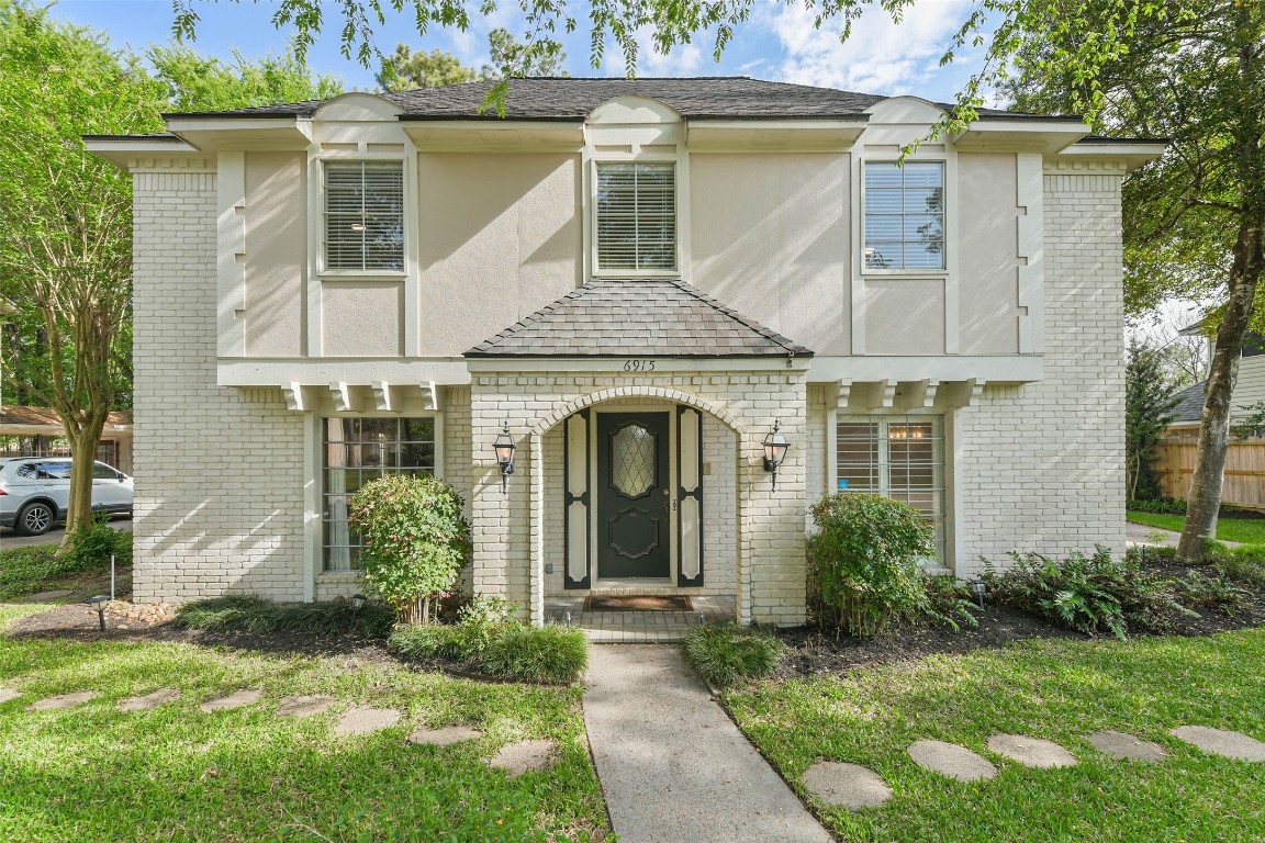 6915 Chancellor Drive Spring, TX 77379 - Photo 2 of 37 a front view of a house with garden