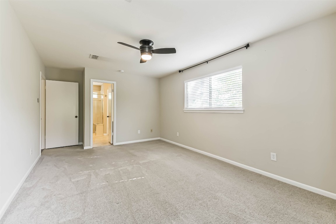 6915 Chancellor Drive Spring, TX 77379 - Photo 22 of 37 an empty room with ceiling fan and windows