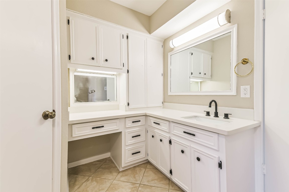 6915 Chancellor Drive Spring, TX 77379 - Photo 23 of 37 a bathroom with a sink vanity and mirror
