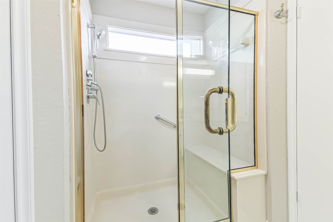 6915 Chancellor Drive Spring, TX 77379 - Photo 24 of 37 a bathroom with a glass shower door
