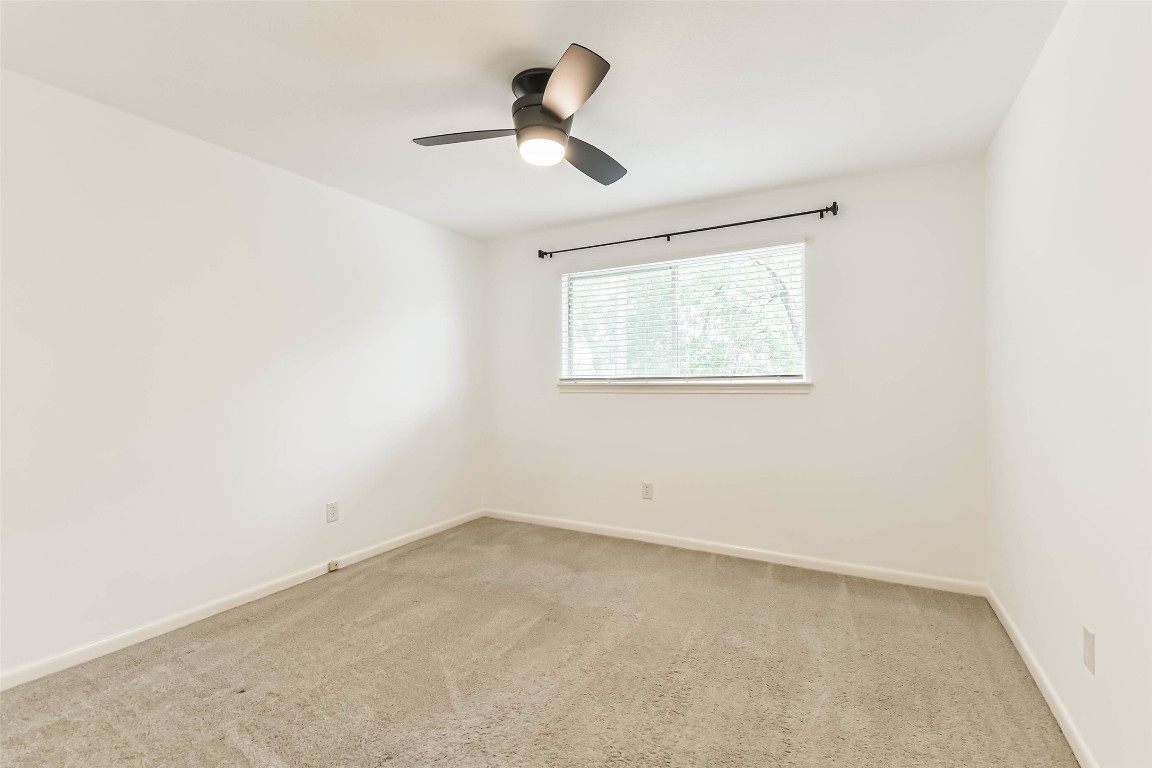 6915 Chancellor Drive Spring, TX 77379 - Photo 29 of 37 an empty room with a window and a ceiling fan