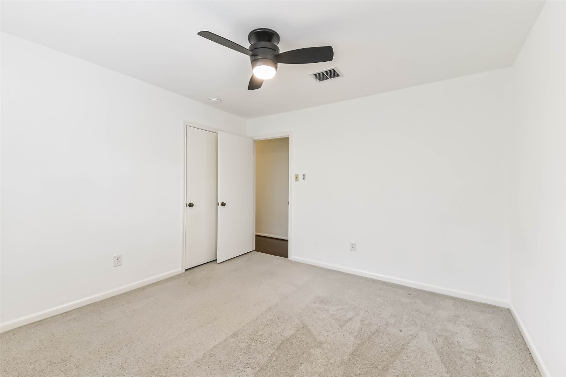 6915 Chancellor Drive Spring, TX 77379 - Photo 30 of 37 an empty room with a ceiling fan and carpet