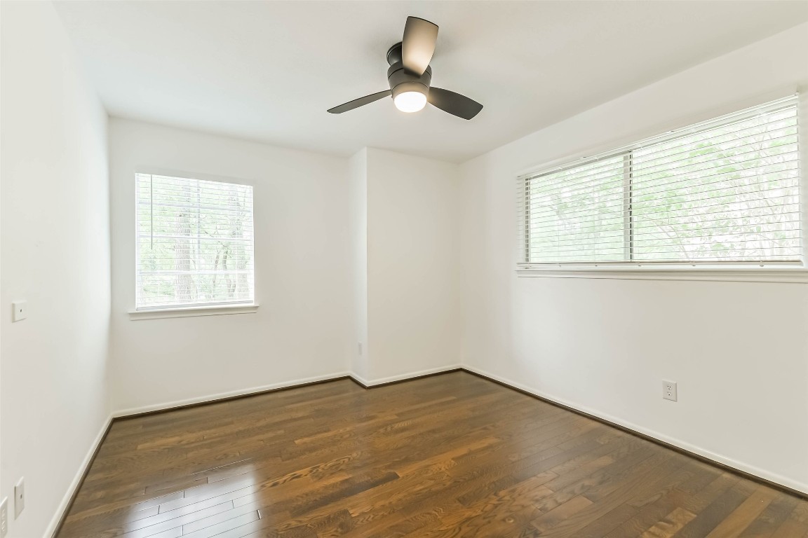 6915 Chancellor Drive Spring, TX 77379 - Photo 31 of 37 a view of empty room with wooden floor and fan