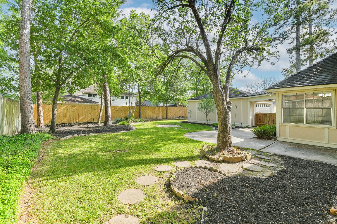 6915 Chancellor Drive Spring, TX 77379 - Photo 33 of 37 a view of a house with backyard and a tree