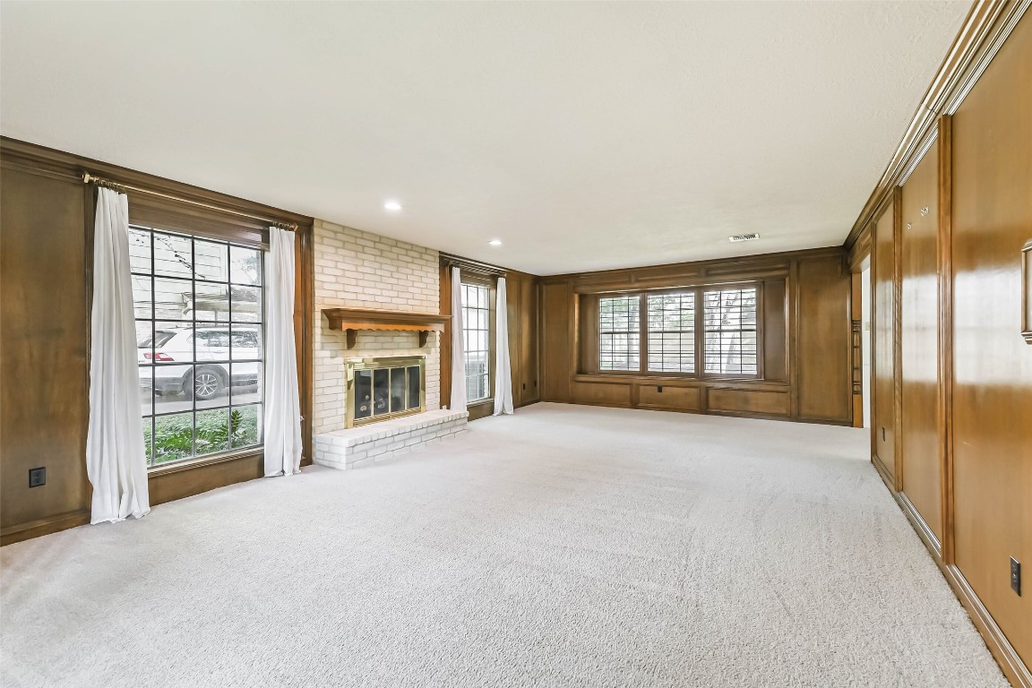 6915 Chancellor Drive Spring, TX 77379 - Photo 4 of 37 a view of an empty room with a fireplace and a large window
