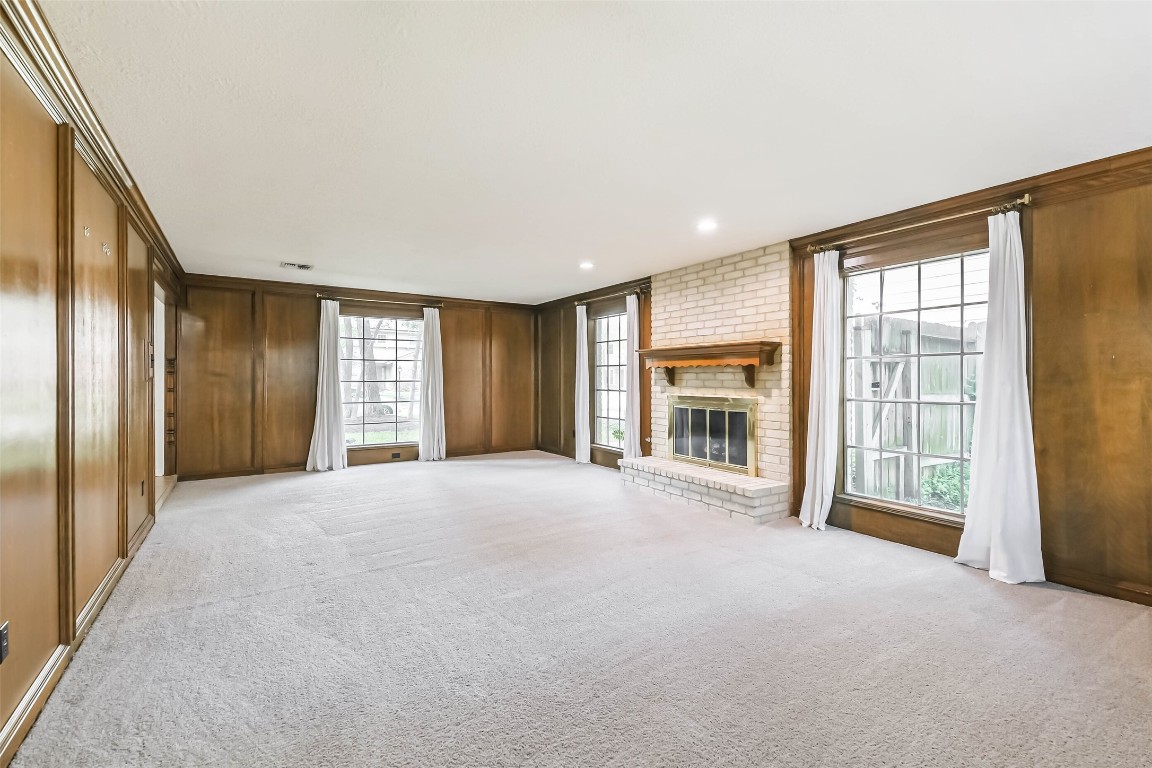 6915 Chancellor Drive Spring, TX 77379 - Photo 5 of 37 a view of an empty room with a fireplace and a window