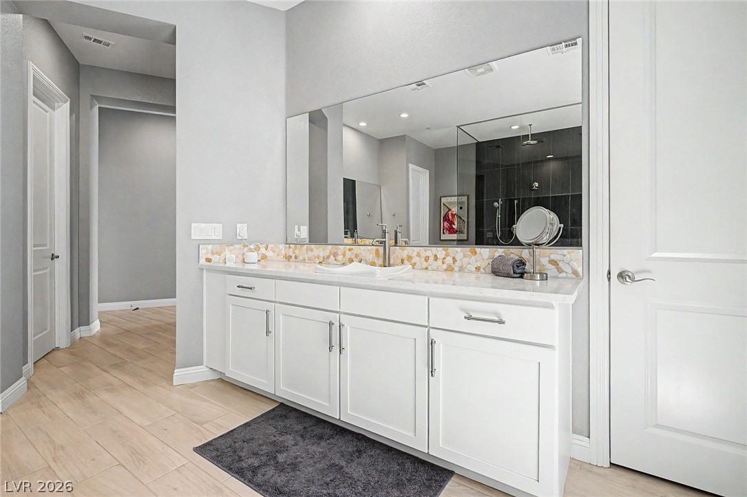 6014 Willow Ridge Court Las Vegas, NV 89135 - Photo 47 of 99 This spacious bathroom offers elegant fixtures and ample counter space for daily routines.
