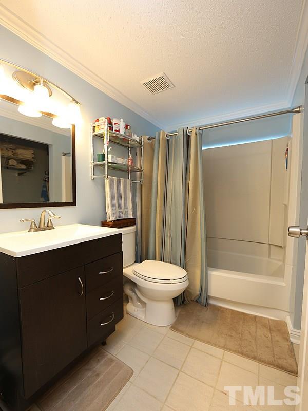 7766 Sandra Lane Raleigh, NC 27615 - Photo 11 of 14 a bathroom with a sink a toilet and shower