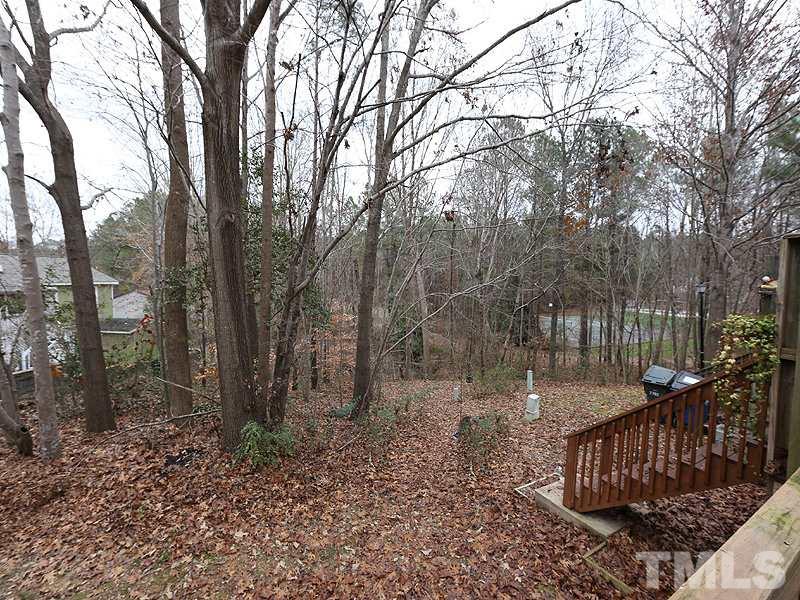 7766 Sandra Lane Raleigh, NC 27615 - Photo 14 of 14 a view of a wooden deck with trees and wooden fence