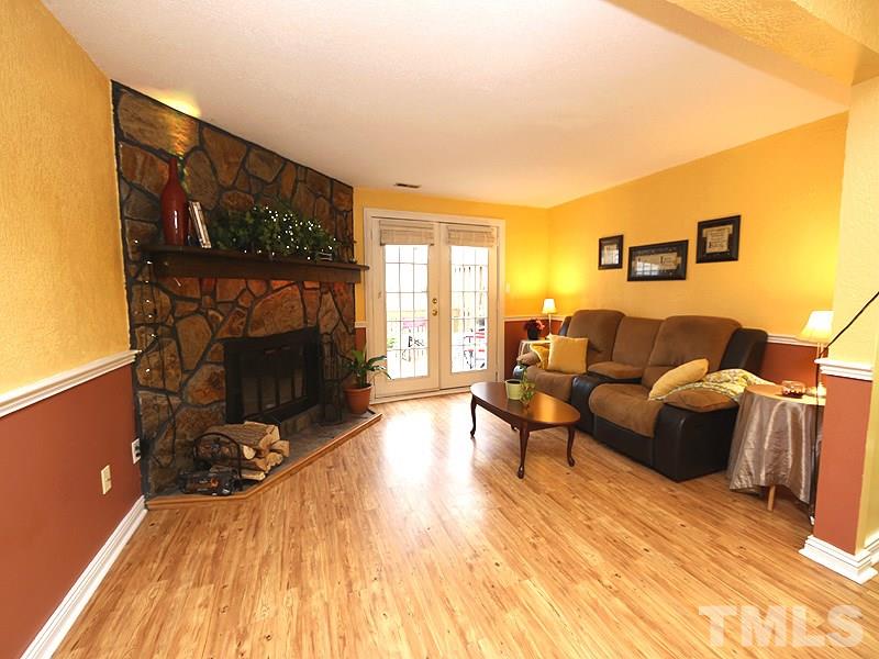 7766 Sandra Lane Raleigh, NC 27615 - Photo 3 of 14 a living room with furniture and a fireplace