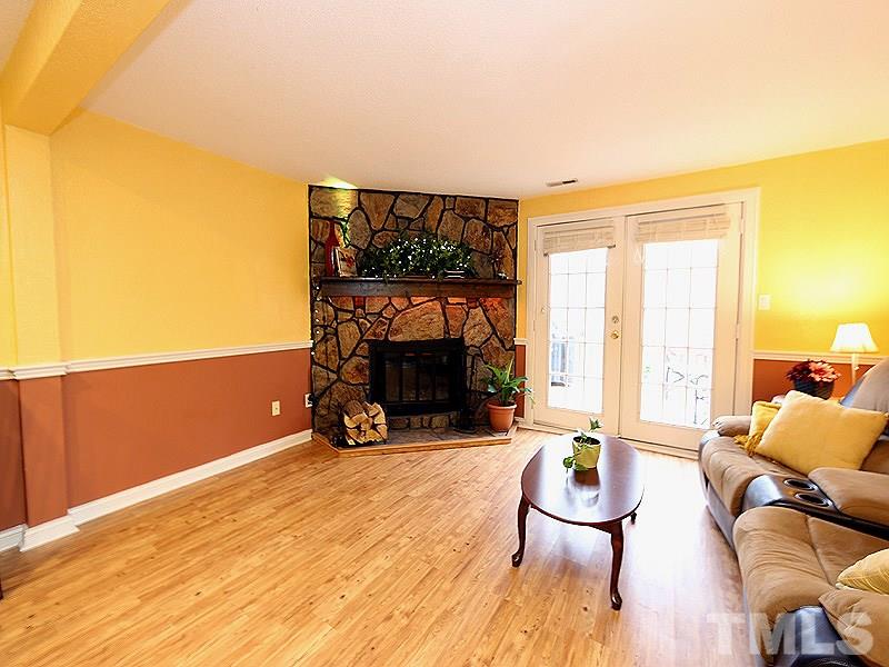 7766 Sandra Lane Raleigh, NC 27615 - Photo 5 of 14 a living room with furniture a fireplace and a large window