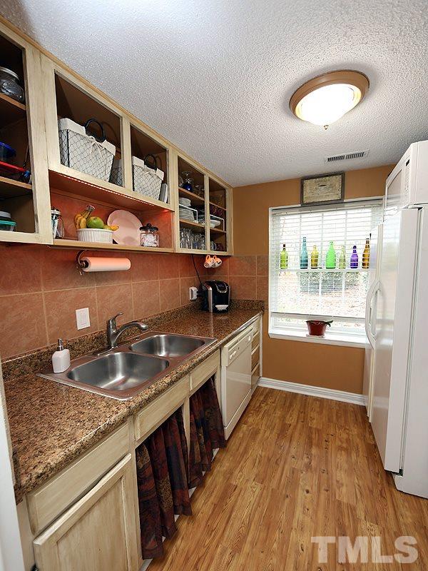 7766 Sandra Lane Raleigh, NC 27615 - Photo 7 of 14 a kitchen with a sink and a refrigerator