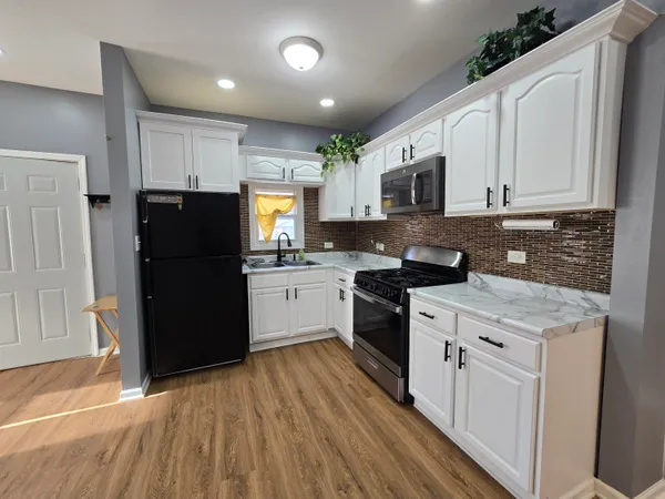 a kitchen with a refrigerator stove and sink