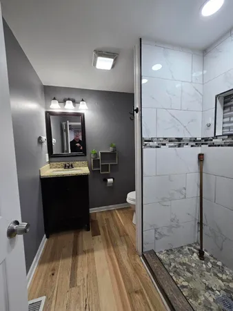 a kitchen with kitchen island granite countertop a refrigerator and a sink