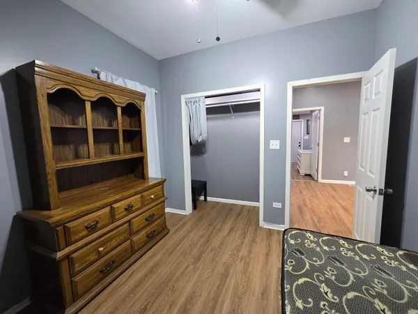 a view of walk in closet with wooden floor