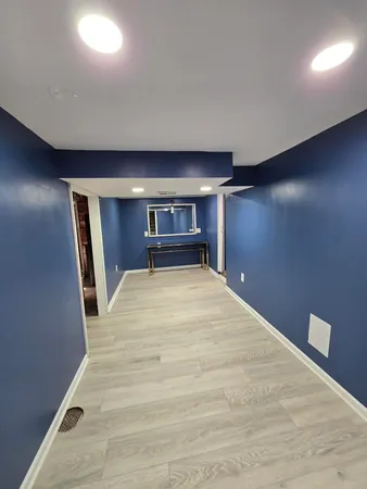 a big room with wooden floor and staircase