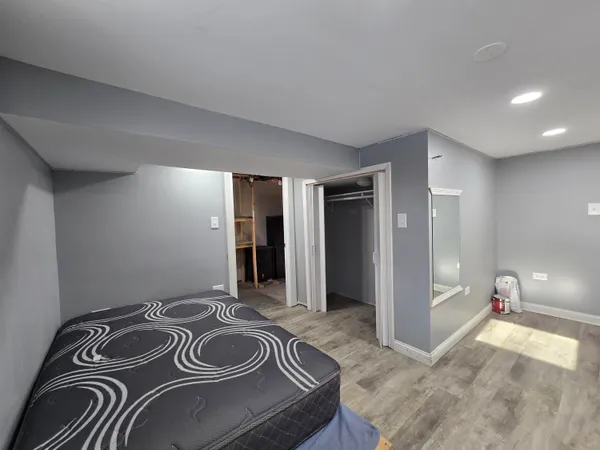 a bedroom with a bed and a sink