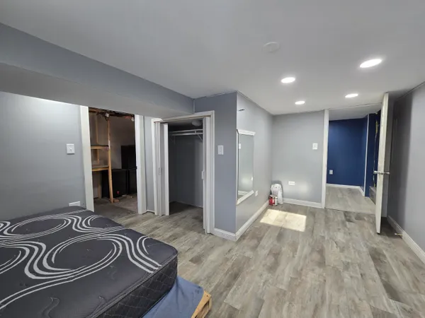 a spacious bedroom with a bed and a sink