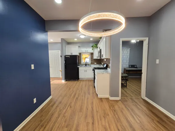 a kitchen with a refrigerator and a sink