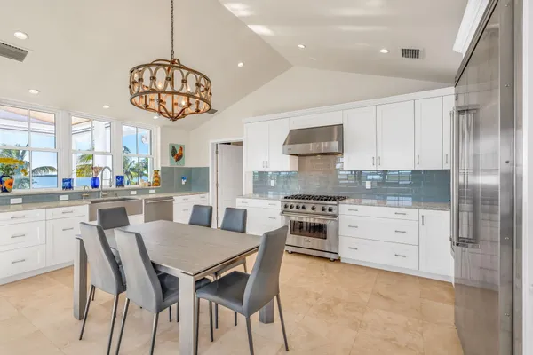 a dining room with furniture a chandelier and window