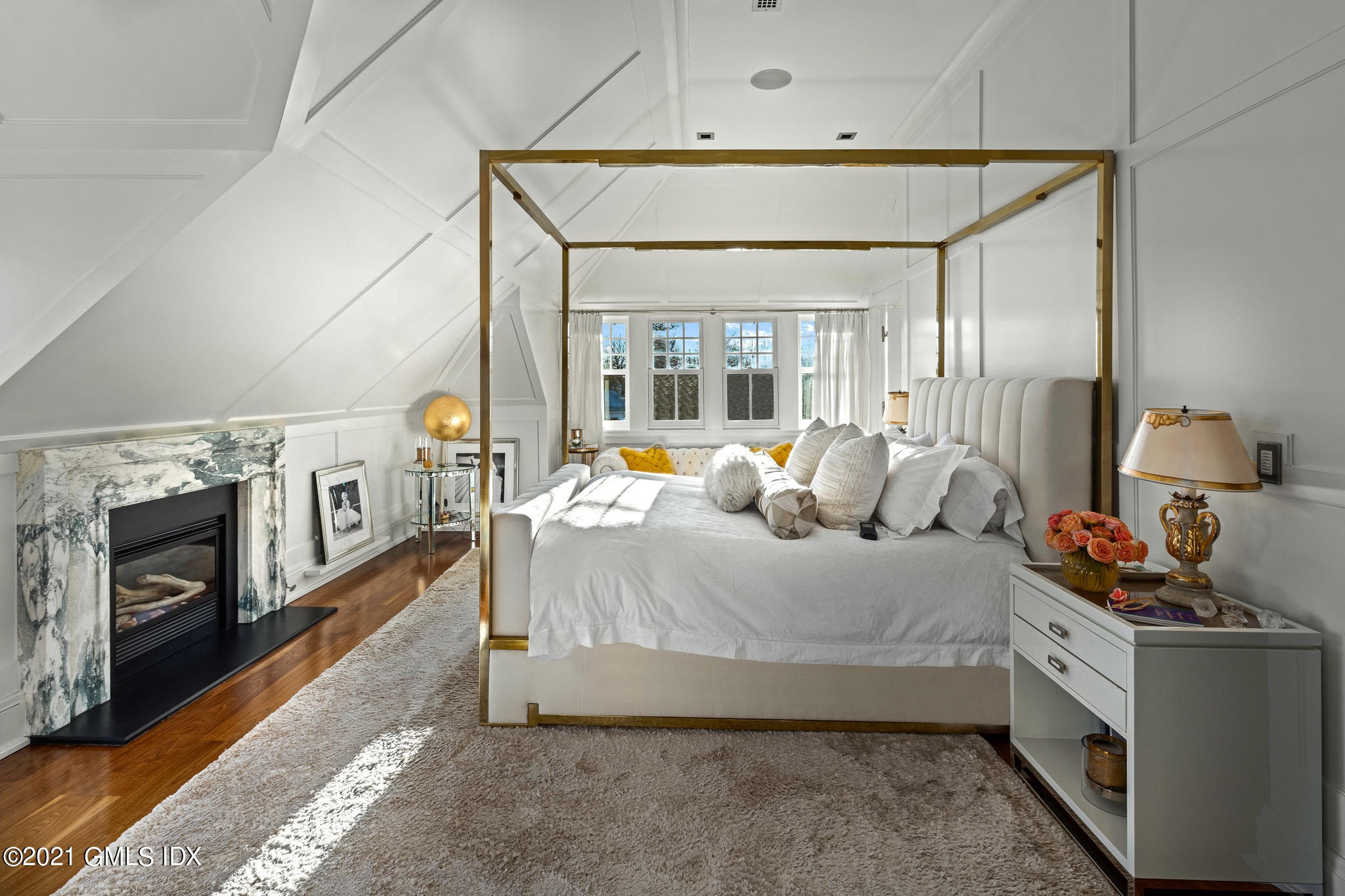 55 Byram Shore Road Greenwich, CT 06830 - Photo 13 of 30 a bedroom with a bed and a fireplace