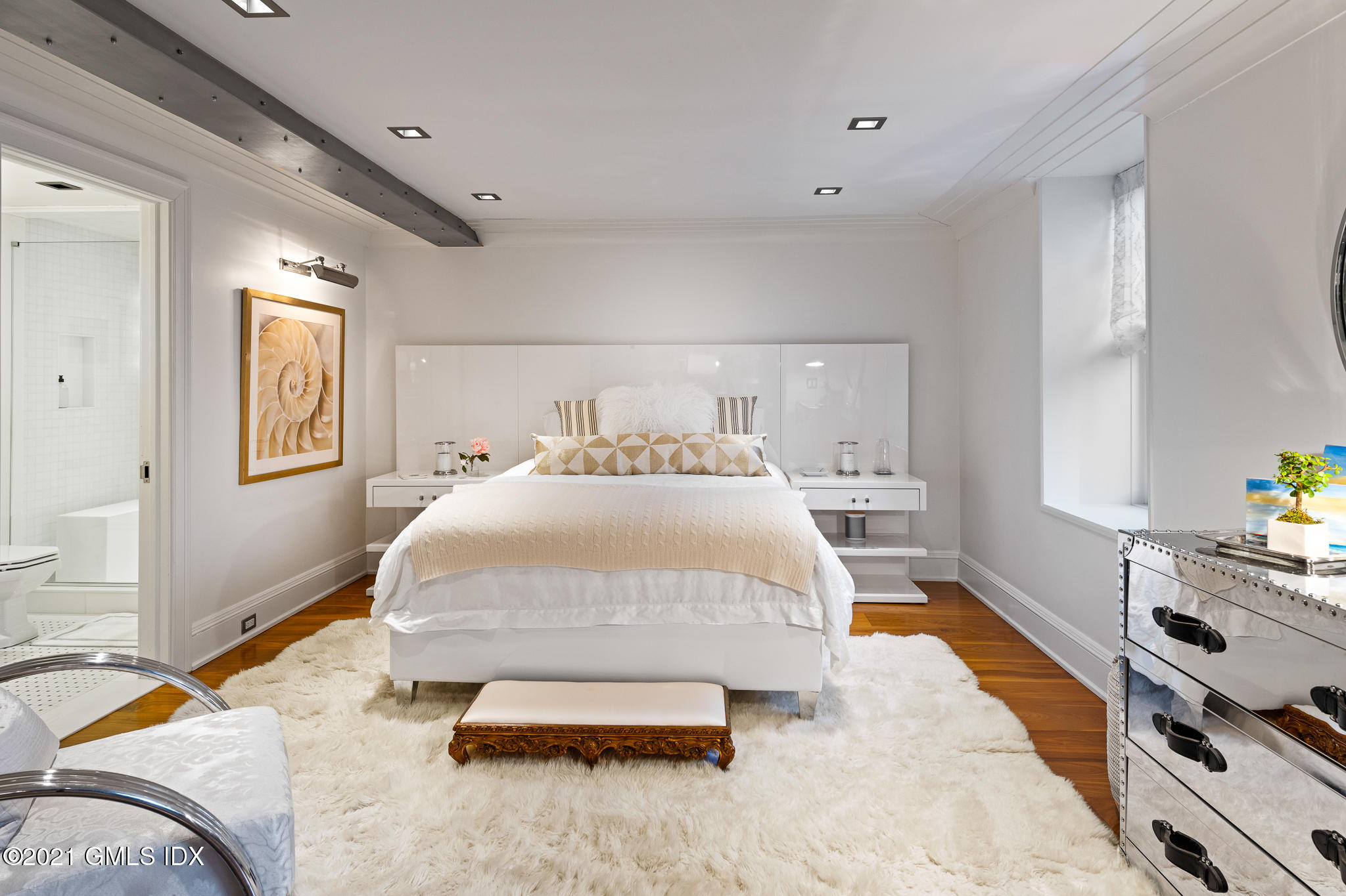 55 Byram Shore Road Greenwich, CT 06830 - Photo 20 of 30 a spacious bedroom with a bed and window