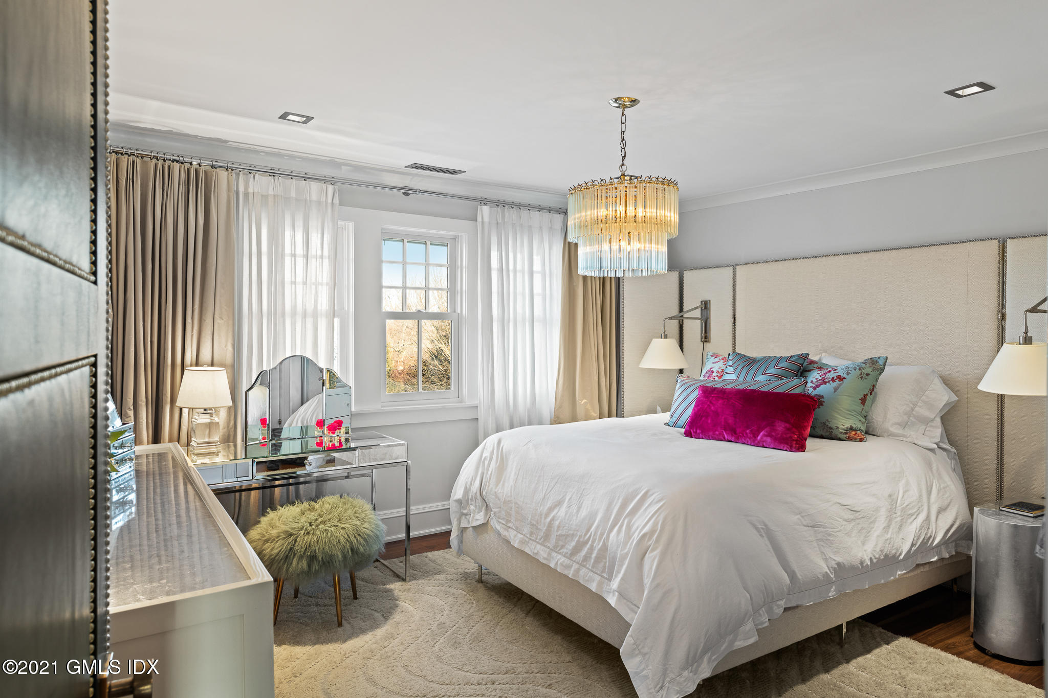 55 Byram Shore Road Greenwich, CT 06830 - Photo 22 of 30 a bedroom with a bed and a chandelier