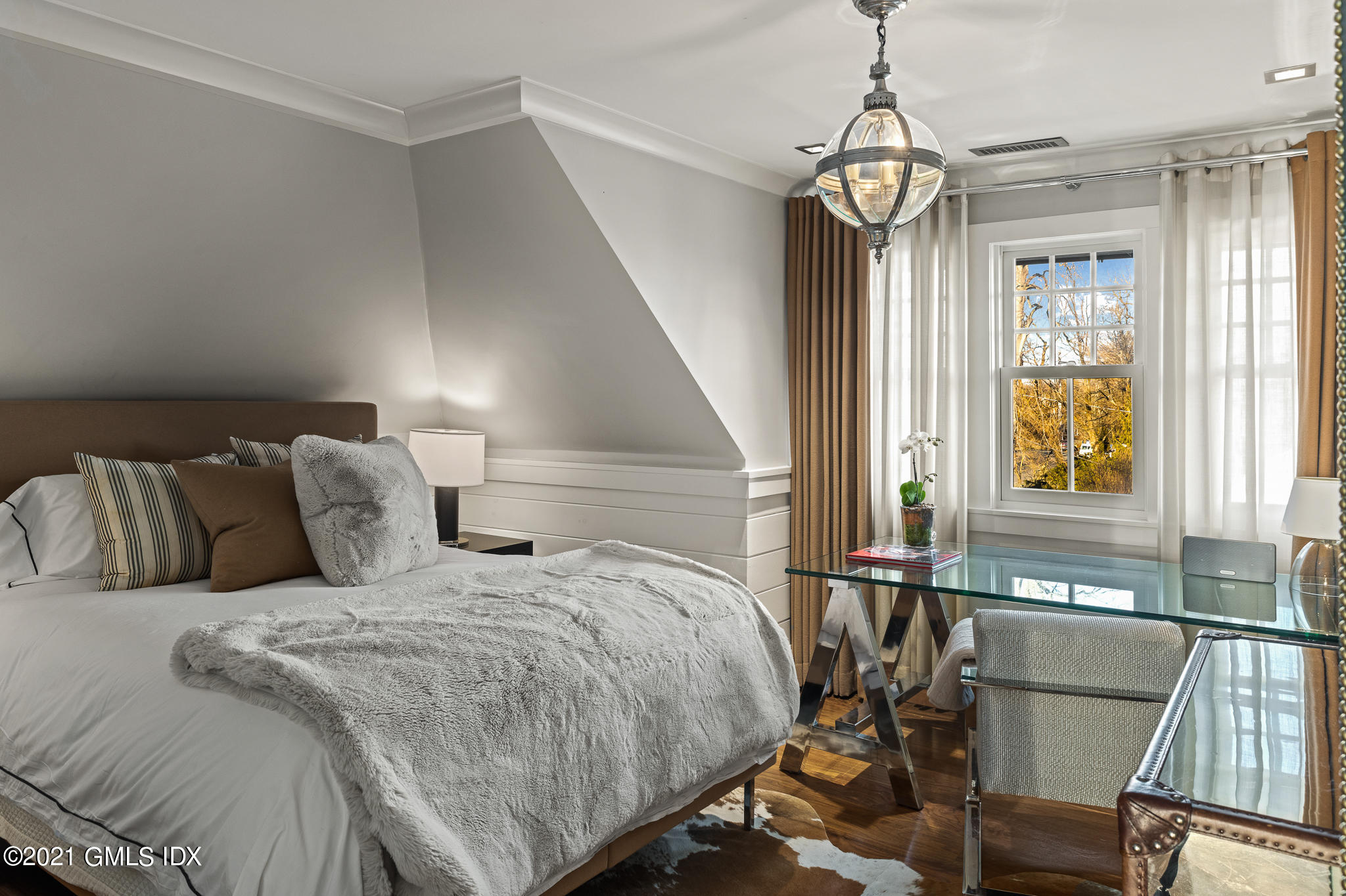 55 Byram Shore Road Greenwich, CT 06830 - Photo 23 of 30 a bed room with a bed and a chandelier