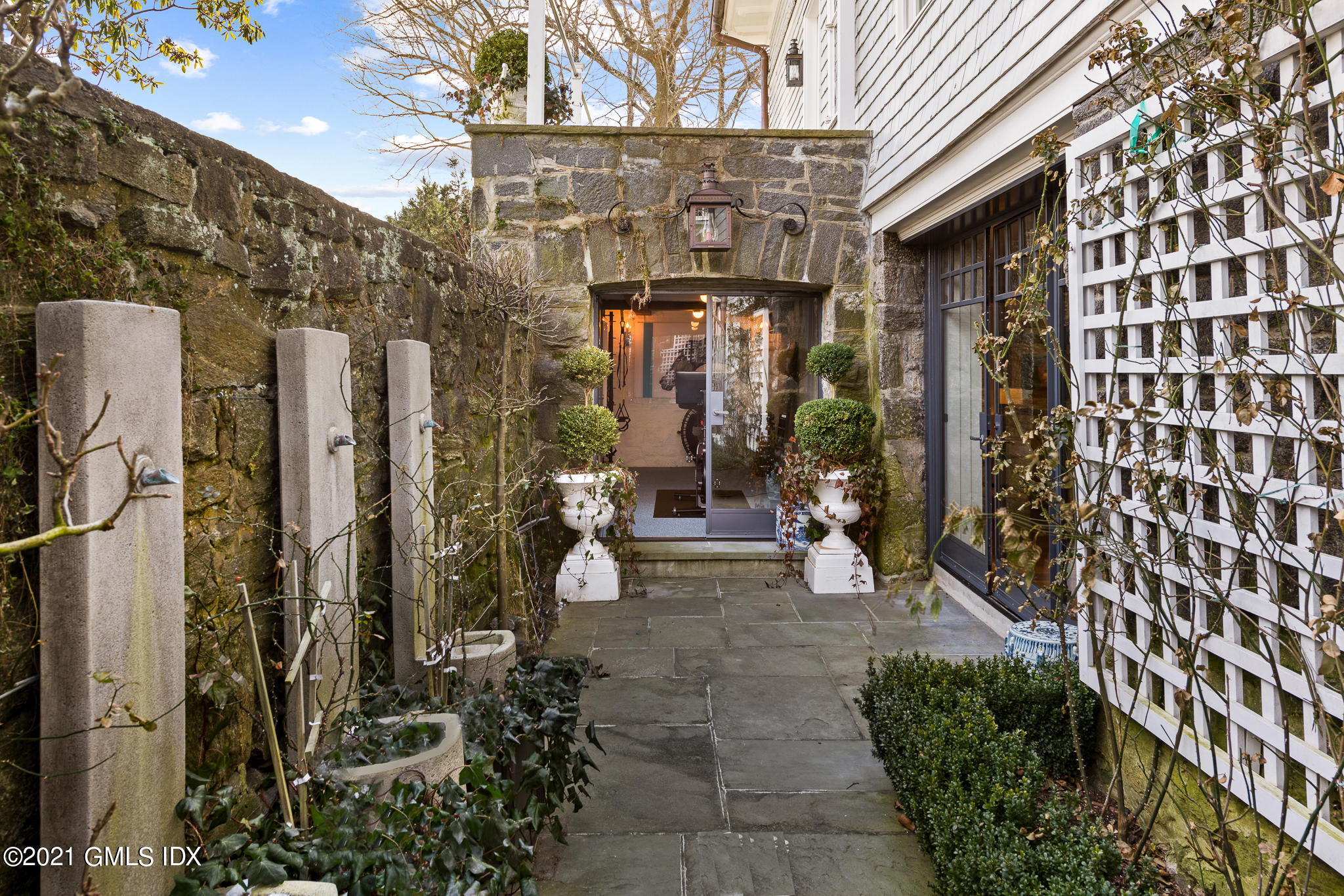 55 Byram Shore Road Greenwich, CT 06830 - Photo 26 of 30 a view of a house with potted plants