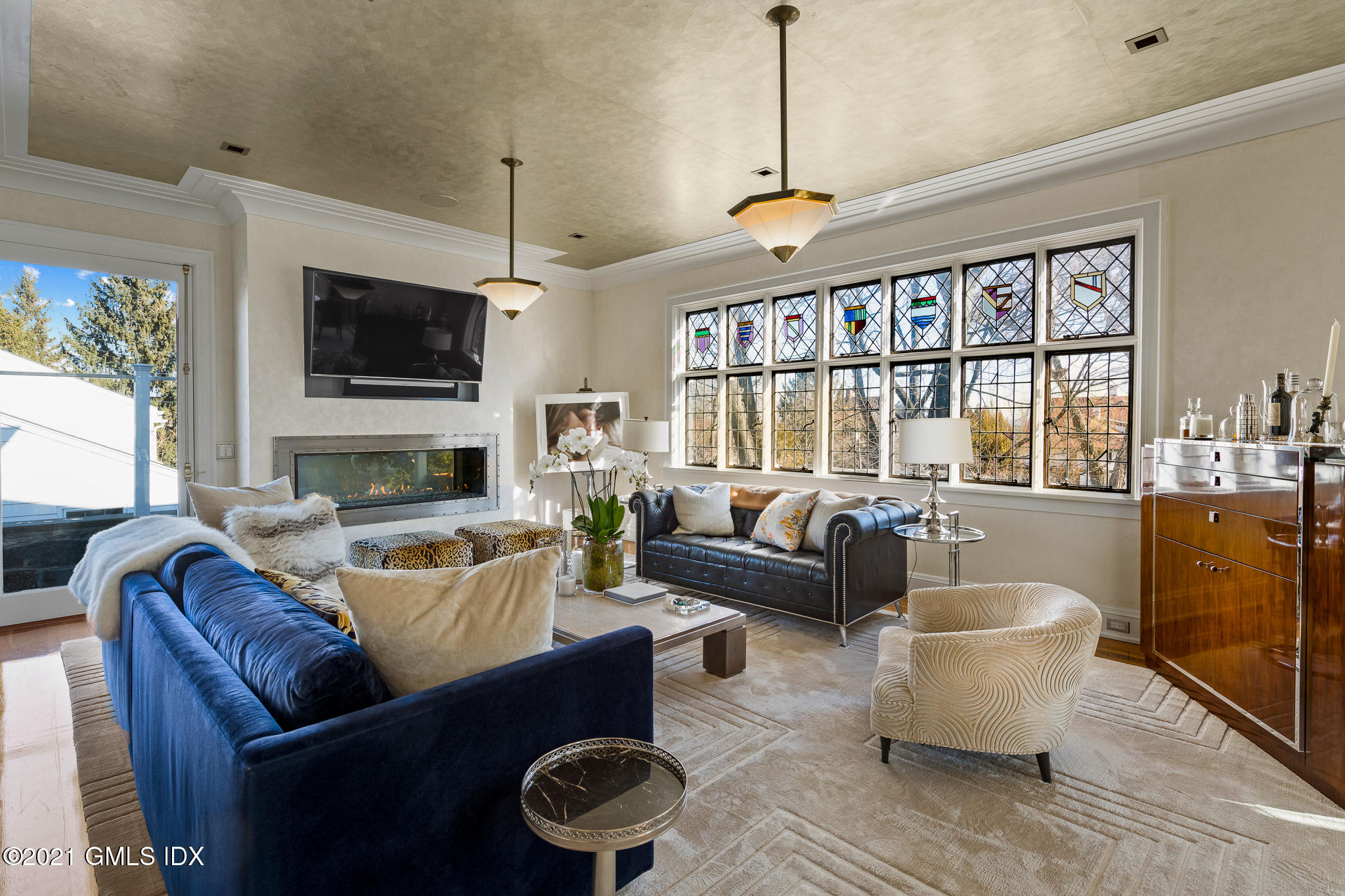 55 Byram Shore Road Greenwich, CT 06830 - Photo 4 of 30 a living room with furniture a flat screen tv and a window