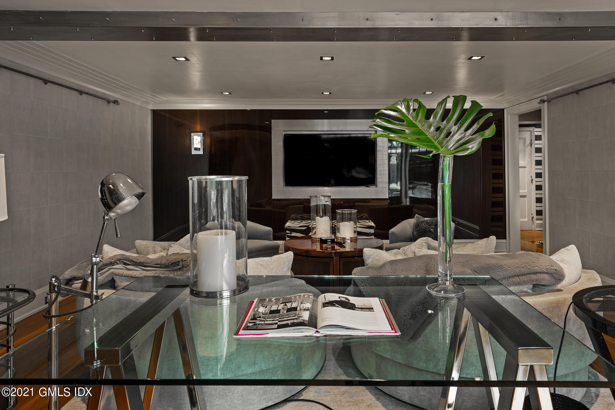 55 Byram Shore Road Greenwich, CT 06830 - Photo 10 of 30 a living room with furniture a flat screen tv and a potted plant