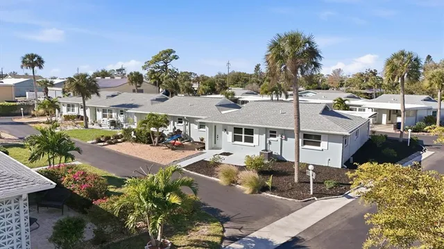 a front view of a houses with yard and street view