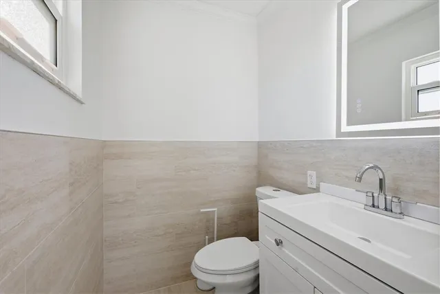 a bathroom with a sink mirror and vanity