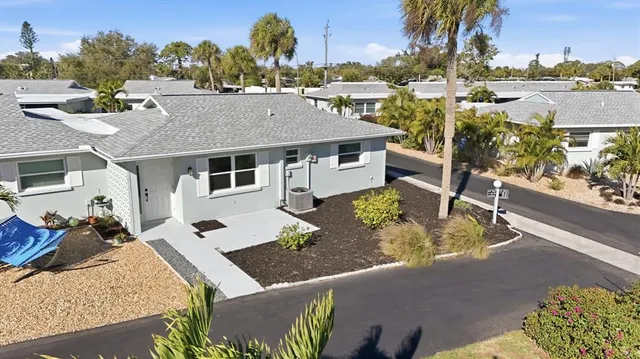a aerial view of a house with a garden and sitting area