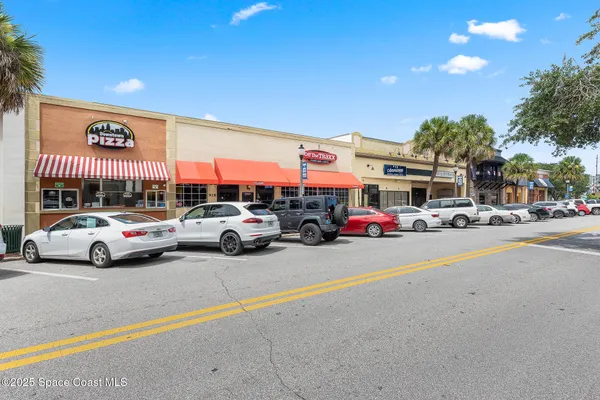 a front view of a building with retail shops