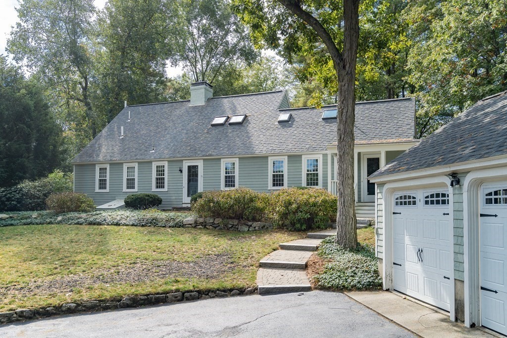 8 Nob Hill Road Wayland, MA 01778 - Photo 2 of 28 a front view of a house with a yard and potted plants