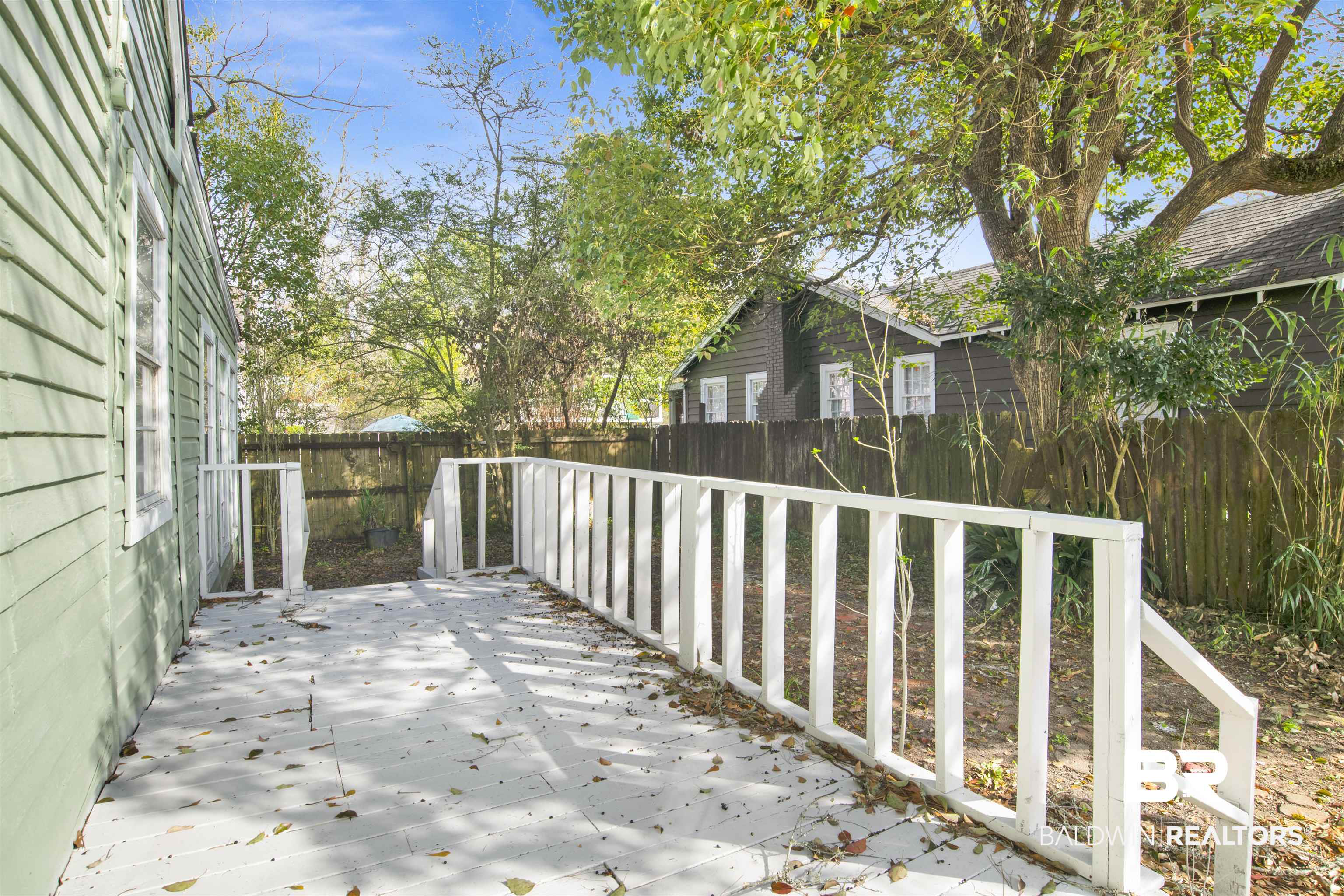 1063 Selma Street Mobile, AL 36604 - Photo 32 of 32 Wooden deck with a fenced backyard