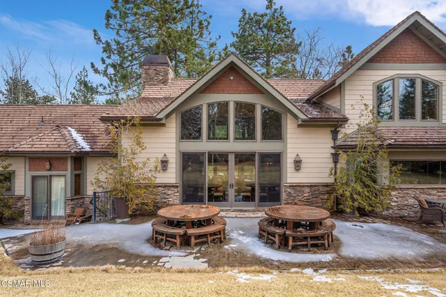 a view of a hallway with wooden floor and furniture