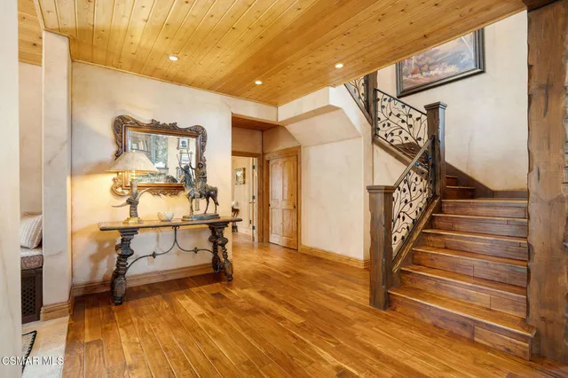 a bedroom with furniture and a flat screen tv