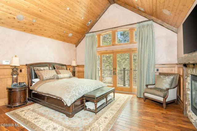 a living room with a fireplace a flat screen tv and a window