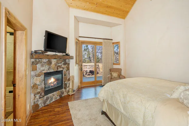 a front view of a house with cars parked