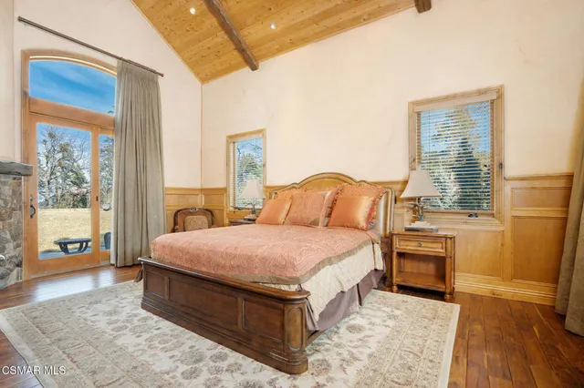 a living room with furniture a rug and a large window