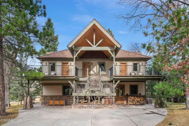 a bedroom with a bed a flat screen tv and balcony view