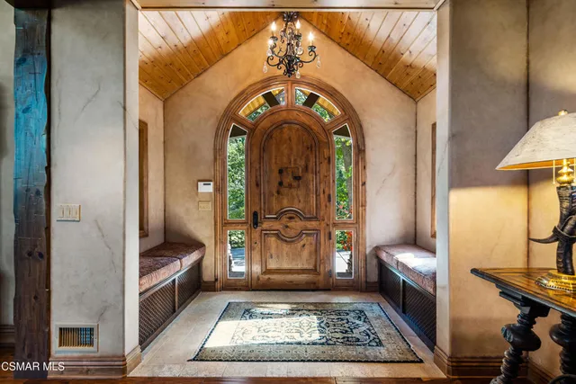 a living room with furniture a fireplace and a large window