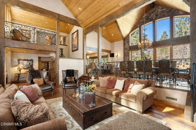 a view of a dining room with furniture large windows and wooden floor