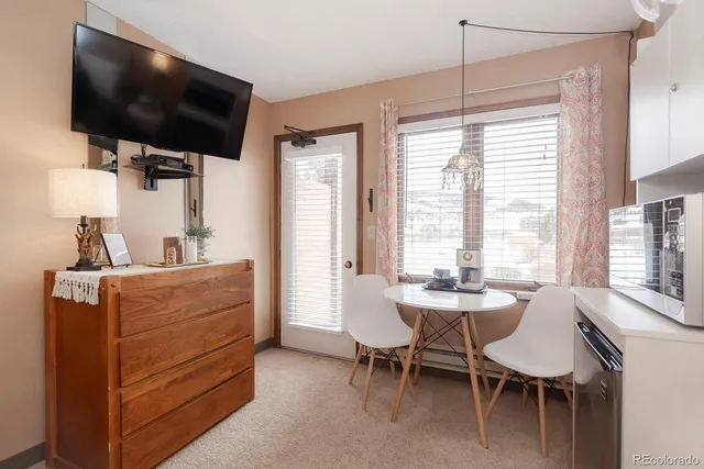 a dining room with furniture and window