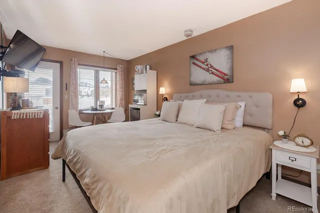 a bedroom with bed and wooden floor