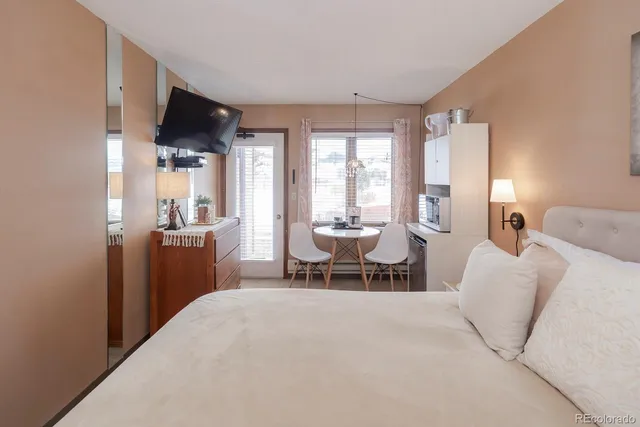 a living room with furniture a large window and a flat screen tv
