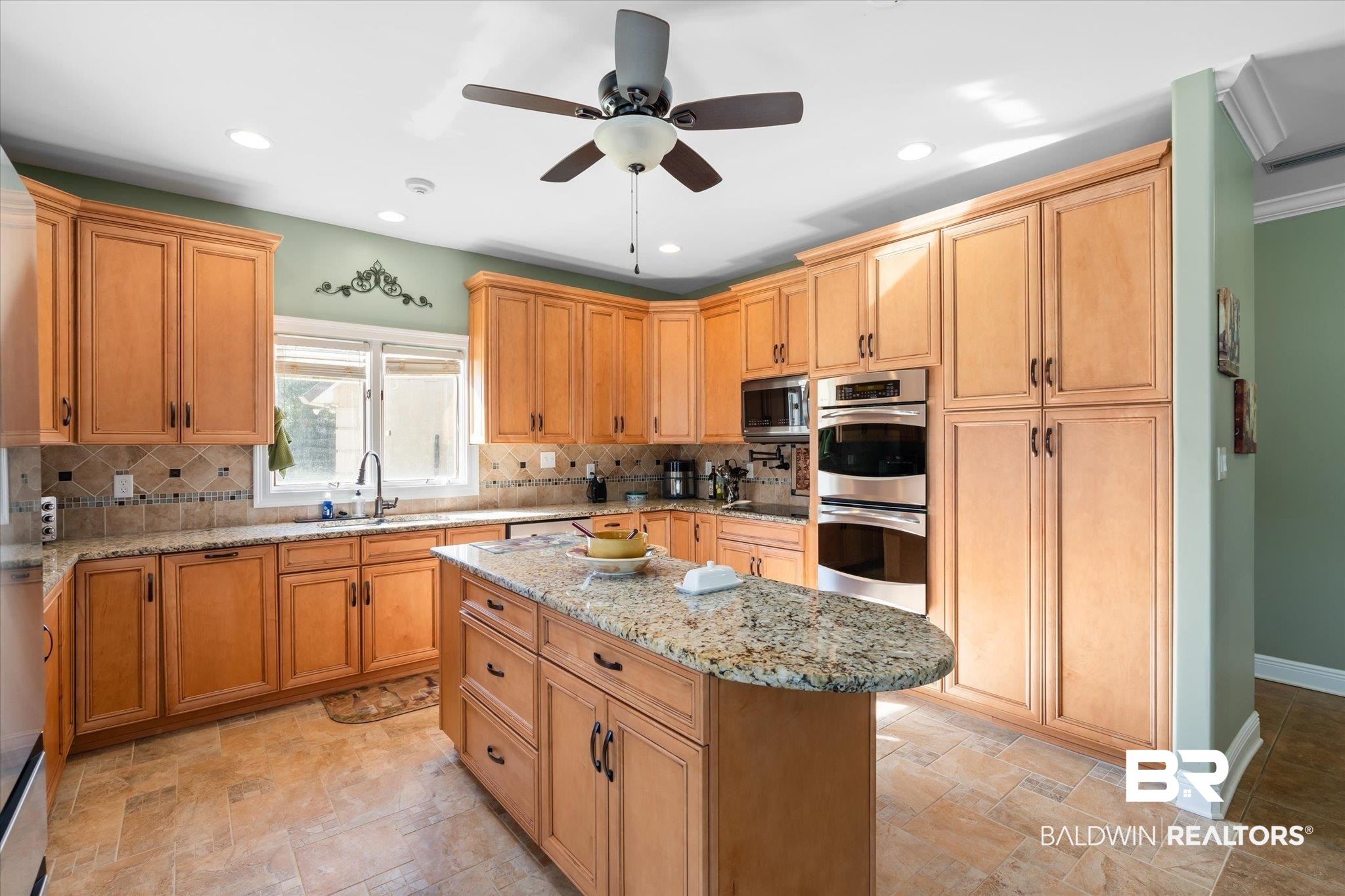 15635 County Road 83 Elberta, AL 36530 - Photo 10 of 54 Kitchen with sink, ceiling fan, light stone countertops, double oven, and a kitchen island