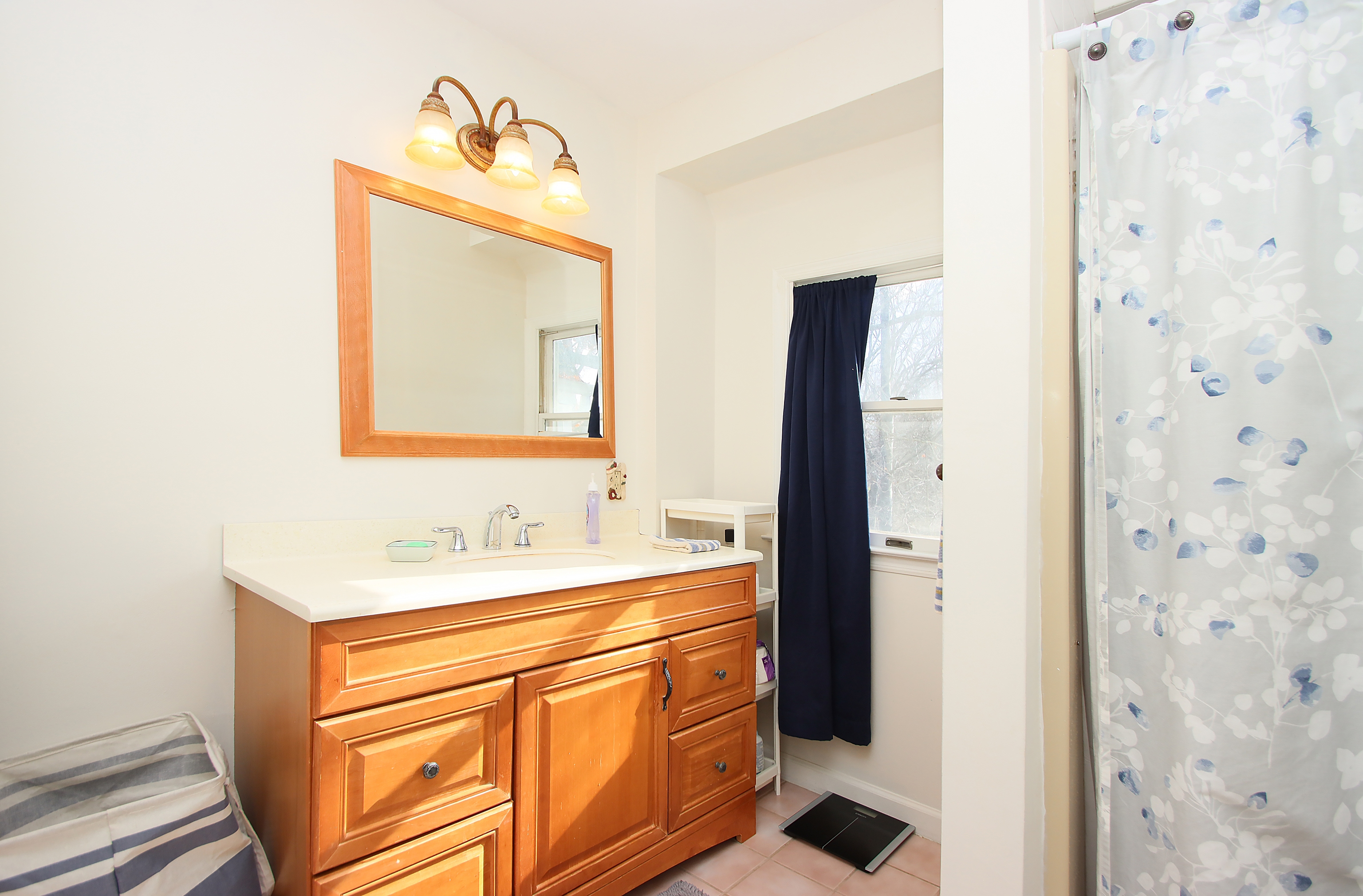 20 Carriage Drive Clinton, CT 06413 - Photo 19 of 31 a bathroom with a sink and a mirror